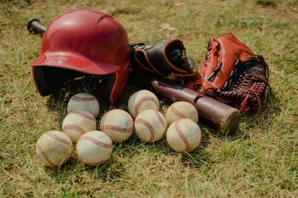 red baseball helmet on green grass field